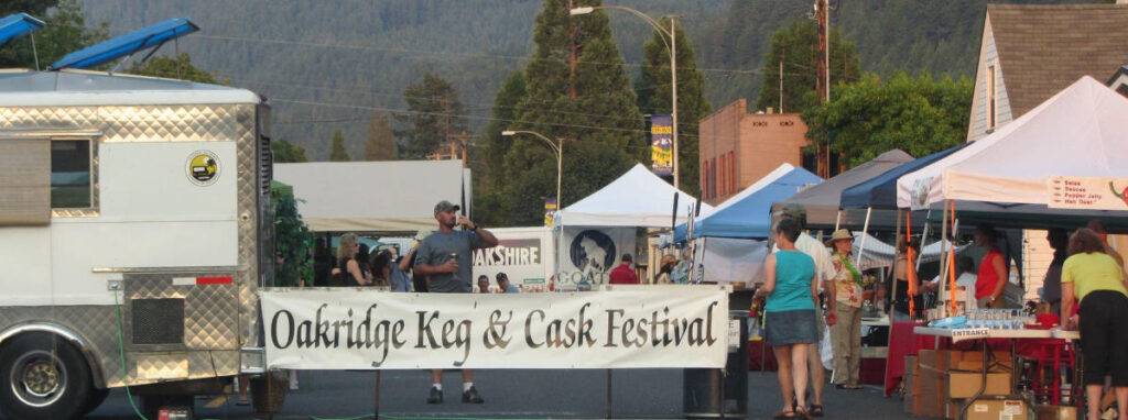 Oakridge, Oregon Keg & Cask Festival: large festival banner with tents and visitors